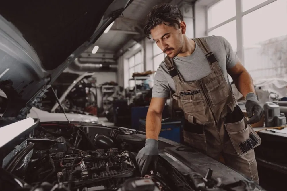 Mechanic checking an engine under the bonnet