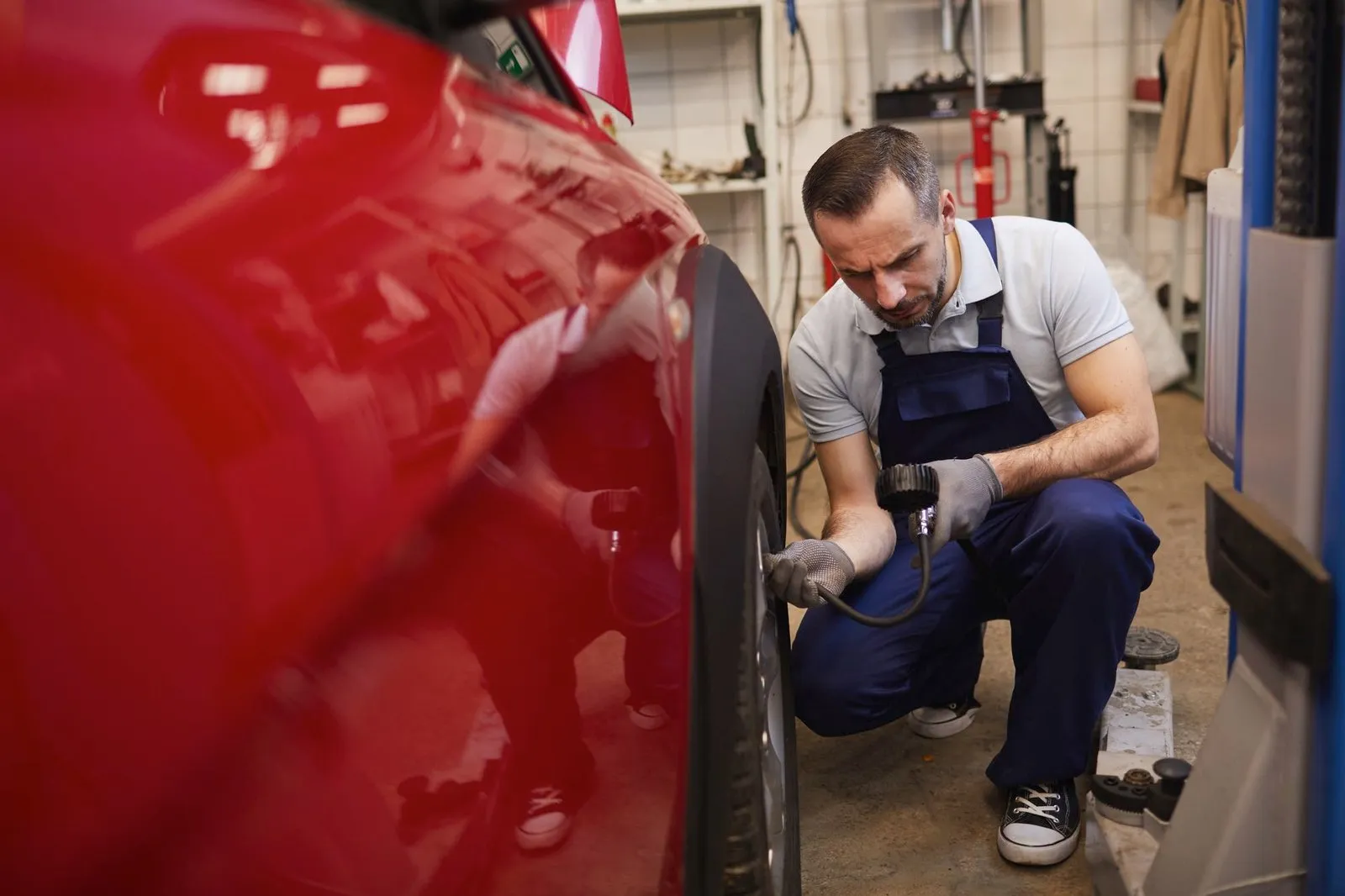 Mechanic checking a car’s tyres